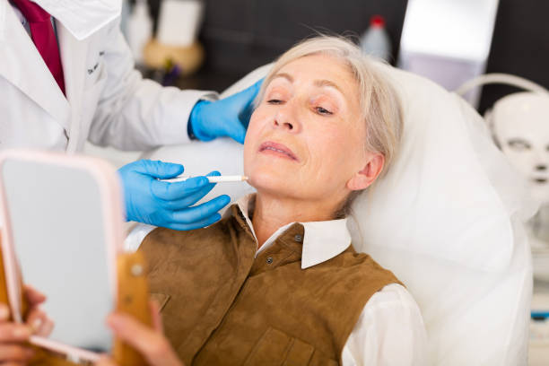 istock Cosmetologist doing botulotoxin injections for senior woman 1477623702