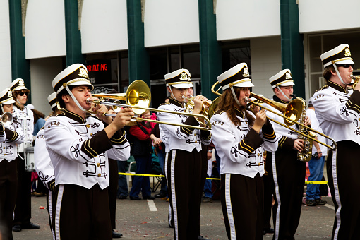 Teenage Boys And Girls Playing Brass Instruments In Marching Band Small Town Parader