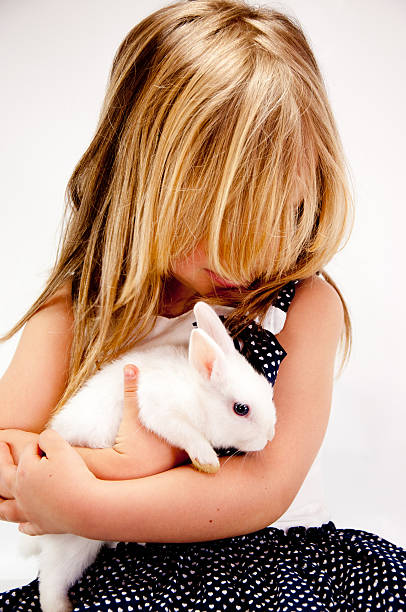 istock Little girl embracing her bunny 147763009