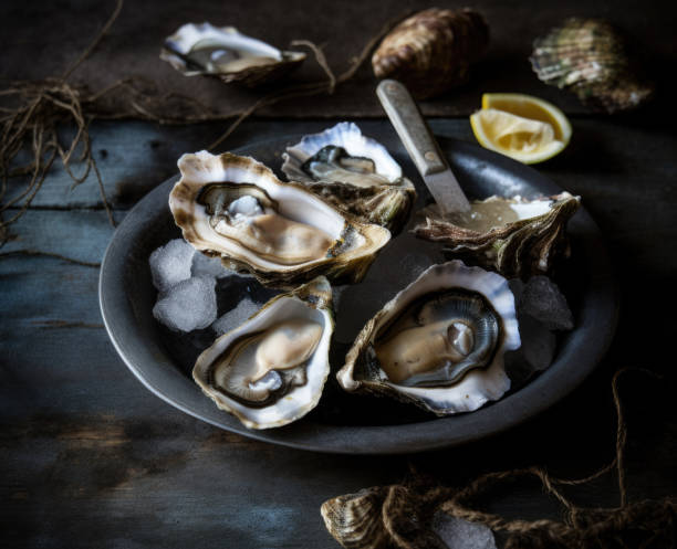istock Fresh Oysters on Rustic Wooden Table 1477634188
