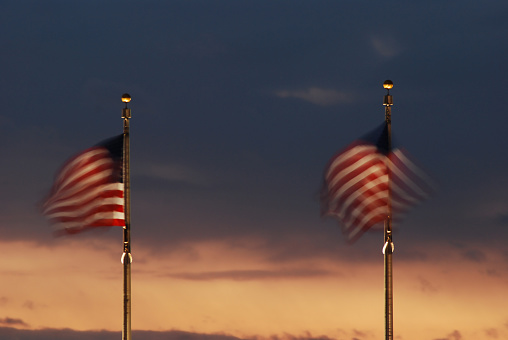 American flags waving at dusk