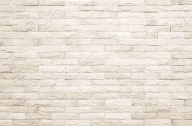 Photo of Background of wide cream brick wall texture. Beige old brown brick wall concrete or stone textured, wallpaper limestone abstract.