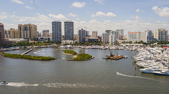 Vibrant Aerial View of the Downtown West Palm Beach, Florida Waterfront Inlet on March 26th, 2023 During Springbreak & the Annual Boat Show at Midday on a Bright Sunny Spring Day