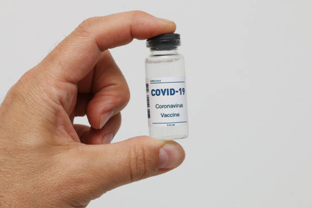 istock Covid-19 vaccine ampoule in hand close-up. 1477641309