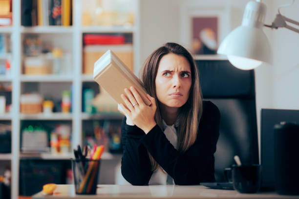 istock Businesswoman Receiving a Package Wondering what is Inside 1477643052