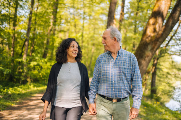 istock Enchanting Retired Couple Walking Around a Pond 1477643567