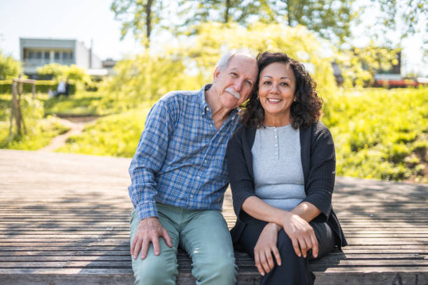 istock Mixed Couple of Senior Lovers Posing at a Park 1477643603
