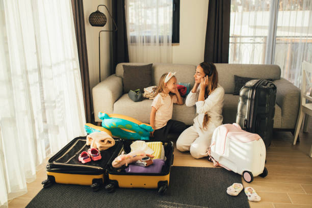 istock Mother and daughter packing before the trip. 1477652751