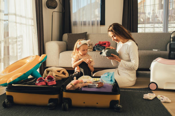 istock Mother and daughter packing before the trip. 1477652758