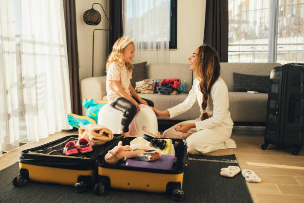 istock Mother and daughter packing before the trip. 1477652762