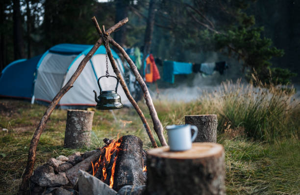 istock Retro teapot hanging over the campfire in the morning. 1477652769
