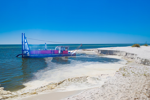 Dredging beach sand at Mexico Beach Florida USA