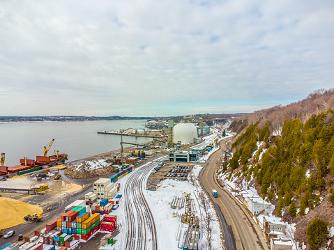 Aerial view of stack of containers by the St. Lawrence river in Quebec city during winter day
