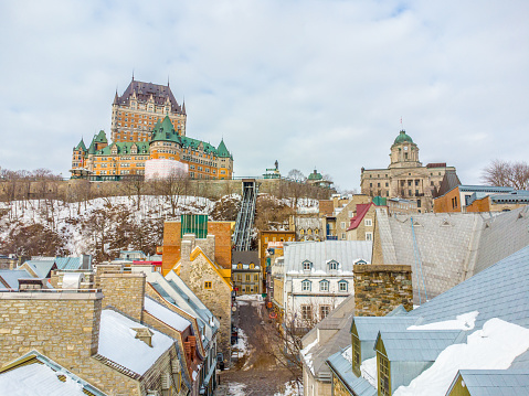 Aerial view of downtown old Quebec city from the Royal Battery Park with Chateau Frontenac hotel and funicular  in background during a day of winter.