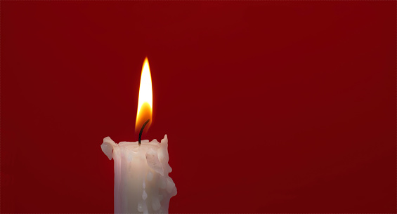 Red candles and baubles on white background. This File is cleaned, retouched and contains 