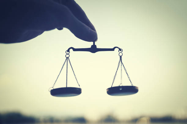 istock person holding scales in the sky 1477665265