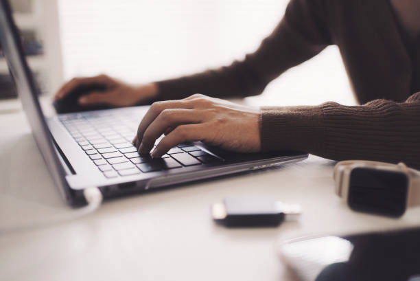 istock Hands of a woman working on a laptop 1477665287