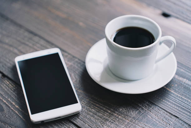 istock Wood table coffee cup and smartphone 1477666521