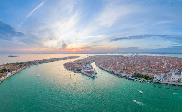 Aerial view of Venice city skyline at sunset, Italy. tourist travel attraction. Aerial Sunset or Sunrise Shot of Central Venice city skyline, Italy. Panorama drone top view of famous tourist attraction from above. Basilica di Santa Maria della Salute, Grand Canal and lagoon. campanile venice stock pictures, royalty-free photos & images