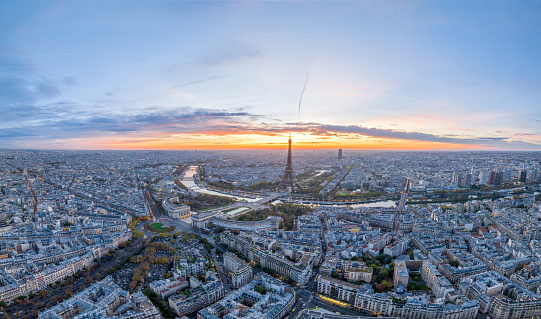 Beautiful view of famous Eiffel Tower in France with colorful twilight romantic sky. Wide establishing aerial morning sunrise or sunset of paris city center best travel destinations landmark in Europe.