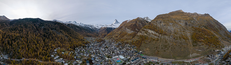 Aerial drone of Zermatt city Valley famous ski resort and iconic Matterhorn peak in autumn season with beautiful landscape in Canton Valais, Switzerland. Swiss alps most popular travel destination.