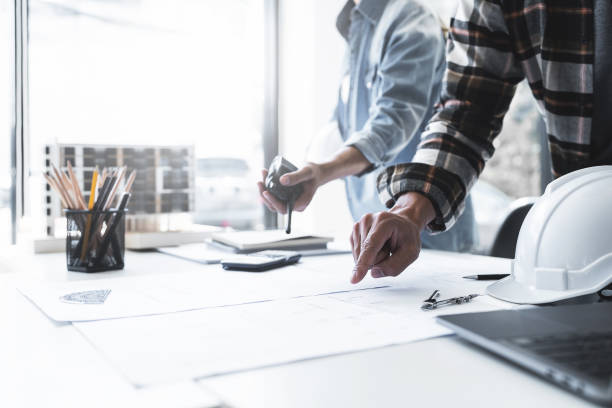 istock Team Work of Architect Engineer Design Working on Blueprint Planning Concept. Construction Concept 1477667838