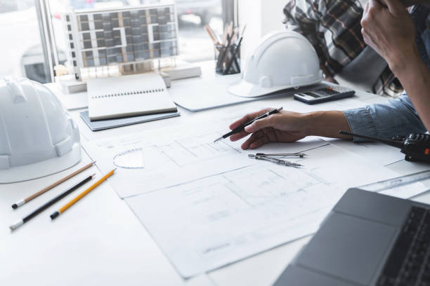 istock Team Work of Architect Engineer Design Working on Blueprint Planning Concept. Construction Concept 1477667839
