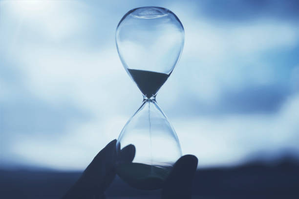 istock Glass hourglass and sunset sky 1477669125