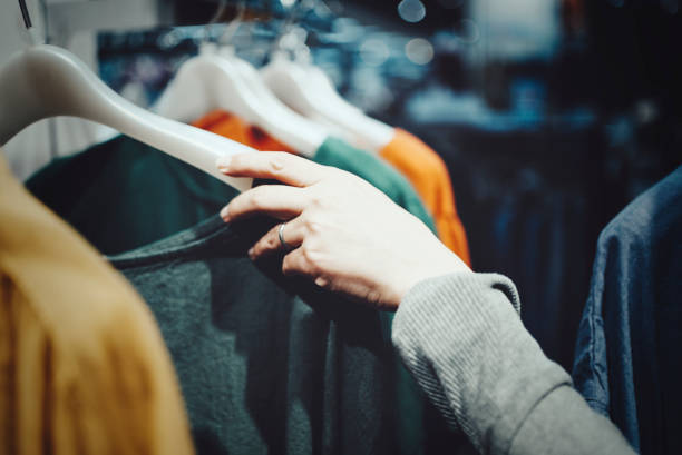 istock Hands of a woman shopping while choosing clothes 1477669906