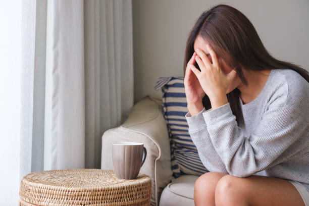istock A young woman feeling sad and stressed, sick and headache at home 1477672112
