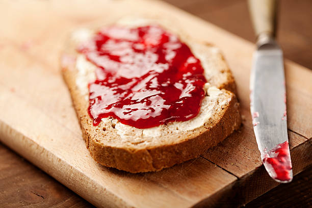 jam on bread strawberry jam on homemade bread raspberry jam stock pictures, royalty-free photos & images
