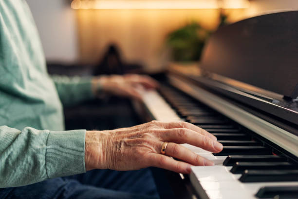Senior man enjoying playing piano at home