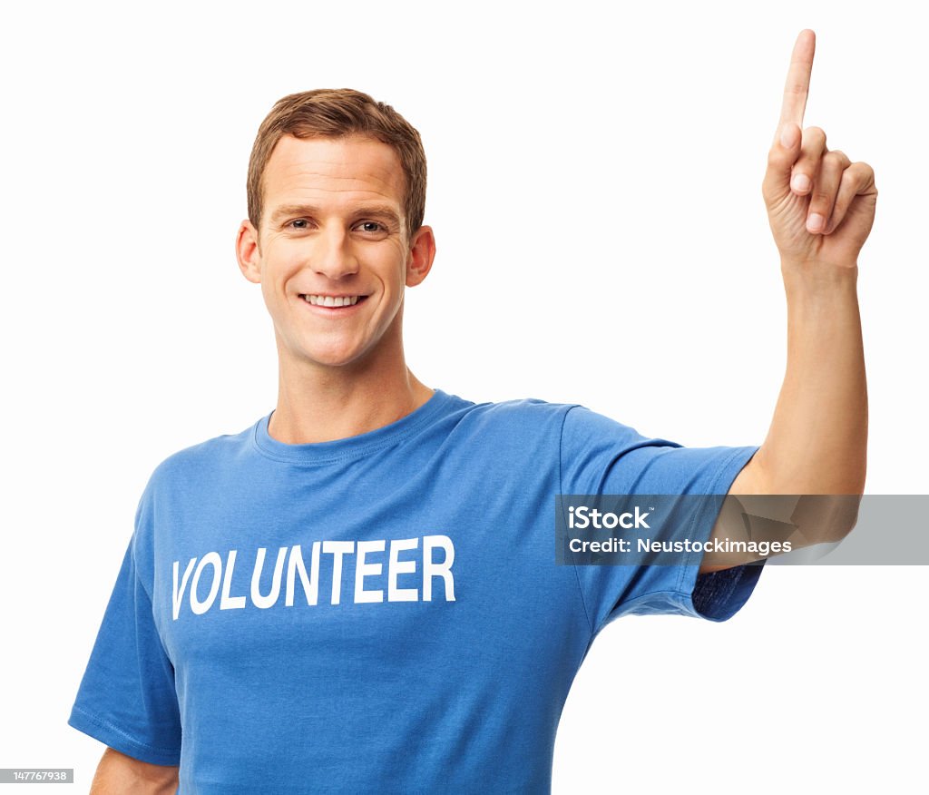 Happy Male Volunteer - Isolated Portrait of handsome young man in a blue volunteer t-shirt pointing up. Horizontal shot. Isolated on white. Volunteer Stock Photo