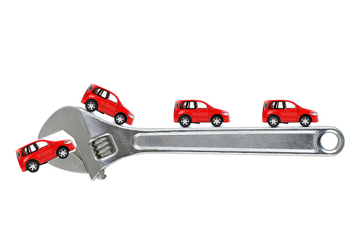 Red toy cars  on wrench. Car service concept. Car repair..