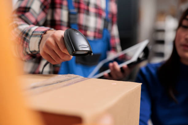 istock Retail storehouse employees doing inventory management while scanning packages 1477679932