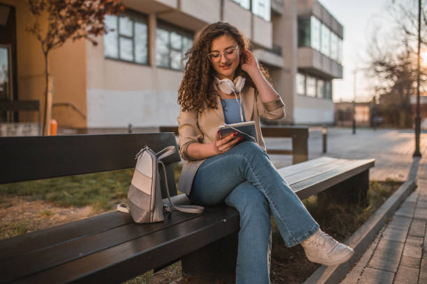 istock A young female student listens to music using a digital tablet and headphones 1477680077