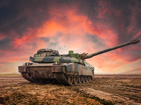 Main battle tank in the vast open field. Dramatic sky background