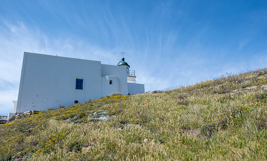 Cyclades, Greece. Kea island. Traditional lighthouse white building against blue sky, sunny Spring day.