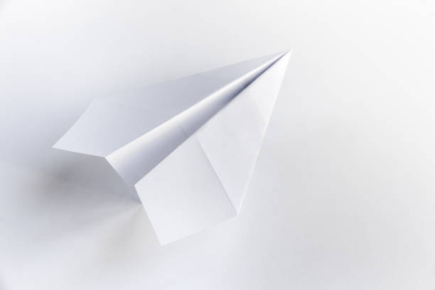 istock Paper plane origami isolated on a white background 1477685061