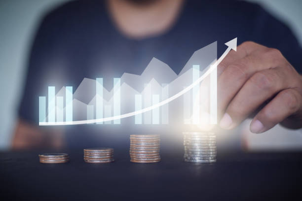 istock Man stacking  a coin with growing graph, money saving and  investment concept. 1477685282