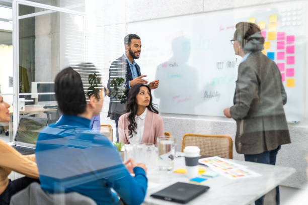 istock Businessman giving presentation on whiteboard 1477690969