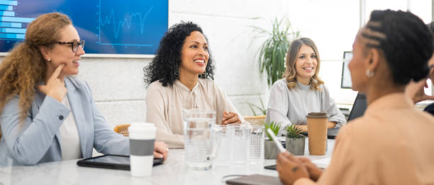 istock Businesswomen talking in boardroom 1477690974