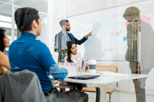 istock Businessman giving presentation on whiteboard 1477691010