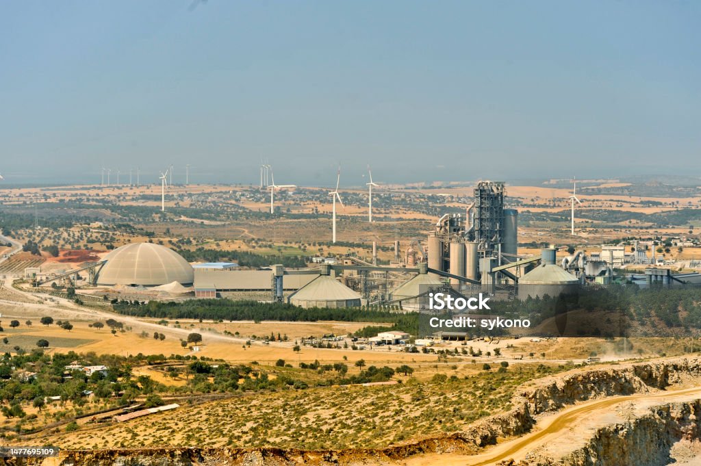 View to Limestone mining for cement with windmills Opencast mining quarry with machinery and mining equipment. Mining - Natural Resources Stock Photo