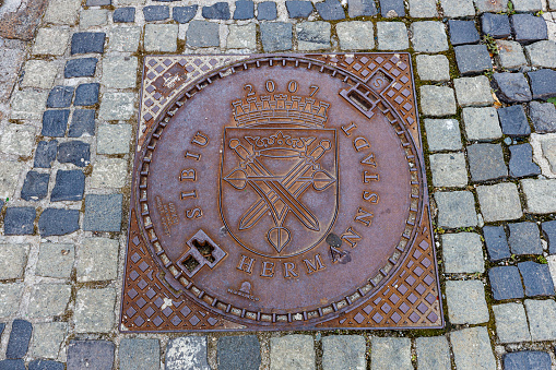 Hermannstadt, Sibiu, Romania - August 08, 2021: Coat of Arms on a Manhole Cover in Sibiu Romania