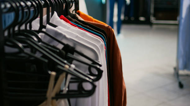 istock Multiple formal or casual clothes hanging in clothing store 1477702046