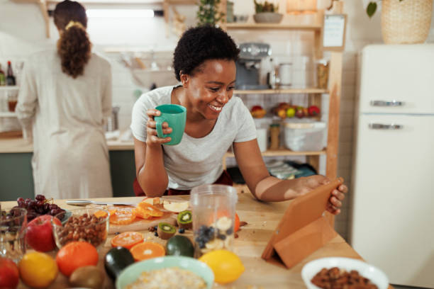 istock Young smiling woman having video call in kitchen 1477702424