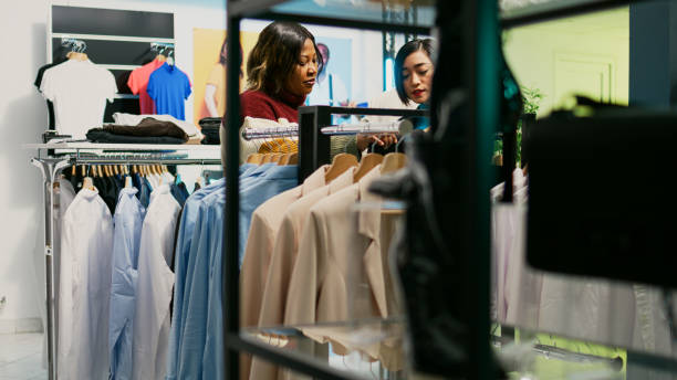 istock Young people talking about fashion collection in store 1477703572