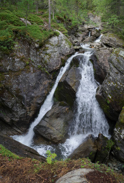 istock Beautiful small waterfall in the mountains with clear cold water. 1477705273