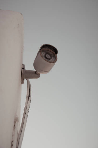 istock Vertical shot of a domestic security camera mounted against a wall 1477706926